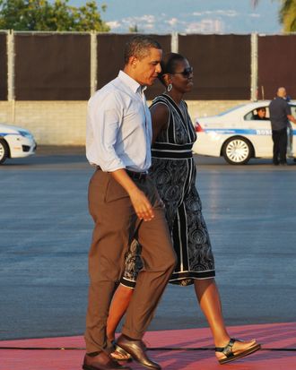 US President Barack Obama and First Lady Michelle Obama make their way to board Air Force One January 2, 2011 at Hickam Air Force Base in Honolulu.