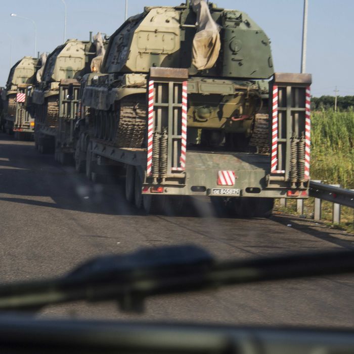 Column of tractors, self-propelled artillery transporting on the highway M 29 in the area of village Kursavka, Stavropol Krai, Russia. Each gun weighs 57 tons. According to the Russian soldiers are heading towards the Russian-Ukrainian border. Accompanied by armored vehicles just one driver. 