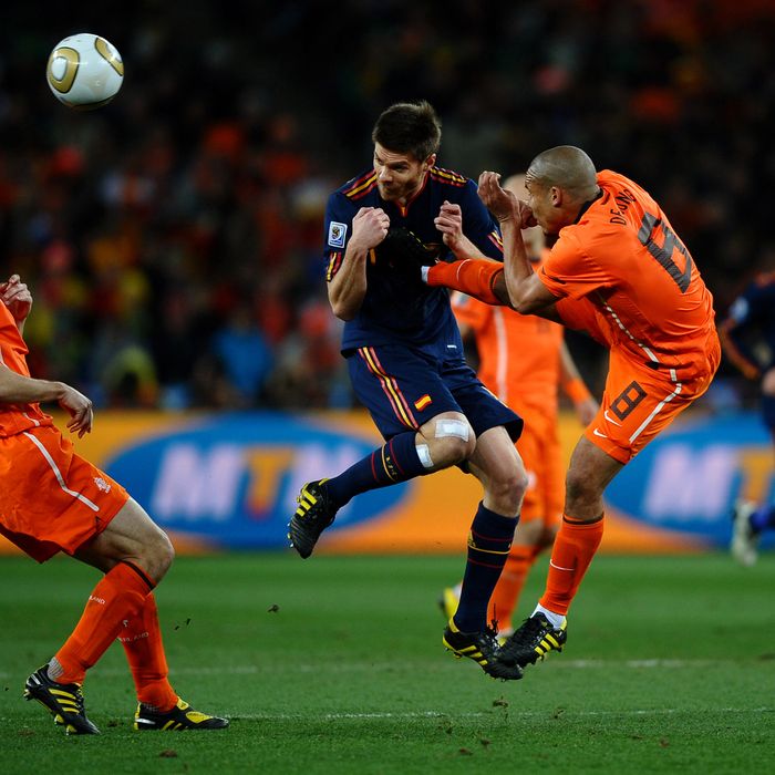 Nigel De Jong of the Netherlands tackles Xabi Alonso of Spain during the 2010 FIFA World Cup South Africa Final match between Netherlands and Spain at Soccer City Stadium on July 11, 2010 in Johannesburg, South Africa. 