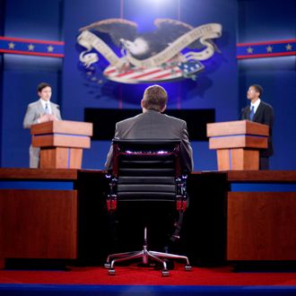 Stand-ins for moderator Jim Lehrer, center, Republican presidential candidate, former Massachusetts Gov. Mitt Romney, left, and President Barack Obama, right, run through a rehearsal for a debate at the University of Denver Tuesday, Oct. 2, 2012, in Denver. 