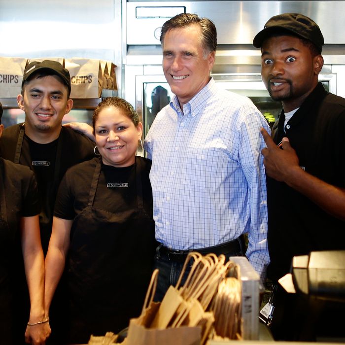 Republican presidential candidate, former Massachusetts Gov. Mitt Romney poses for a photo with workers as he makes an unscheduled stop at a Chipotle restaurant in Denver, Tuesday, Oct. 2, 2012.