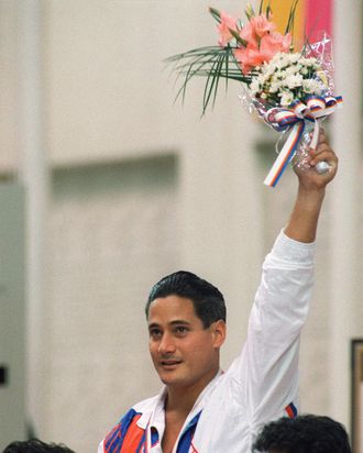 Two-time Los Angeles gold medalist Greg Louganis of the U.S. stands on the podium after winning the Olympic springboard competition, 20 September 2000 in Seoul.