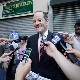 Eliot Spitzer, center, a candidate for New York City comptroller, talks with members of the media as he campaigns in the Jackson Heights neighborhood of the Queens borough of New York, Tuesday, July 23, 2013. Spitzer, who resigned as New York governor in 2008 after admitting he paid for sex with prostitutes, is now attempting a political comeback and is ahead of opponent Scott Stringer in the polls. (AP Photo/Mark Lennihan)
