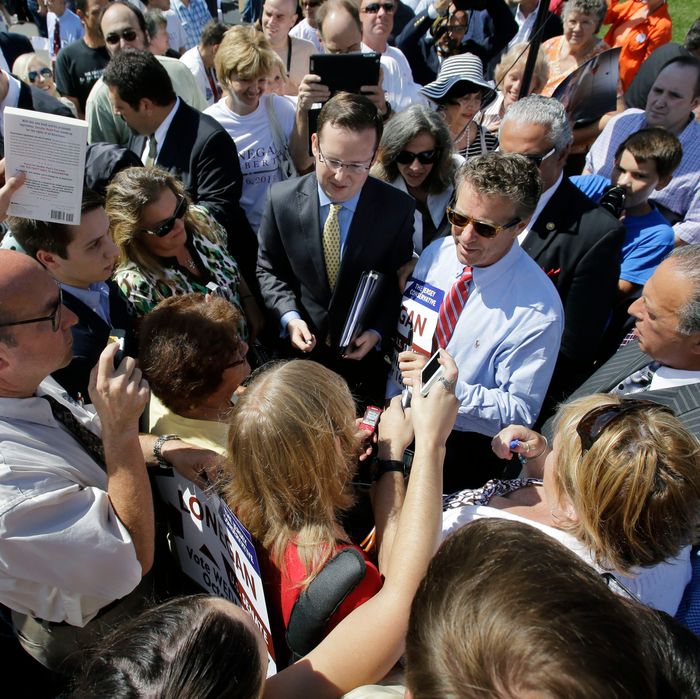 U.S. Sen. Rand Paul, R-Ky., center right in striped tie, is surrounded by supporters seeking autographs, at a rally in Clark, N.J., Friday, Sept. 13, 2013. Earlier, Paul told a crowd of about 200 that candidate for U.S. Senate in New Jersey, Steve Lonegan, will uphold the conservative libertarian principles they both share. Paul slammed Lonegan's Democratic challenger, Newark Mayor Cory Booker. (AP Photo/Mel Evans)