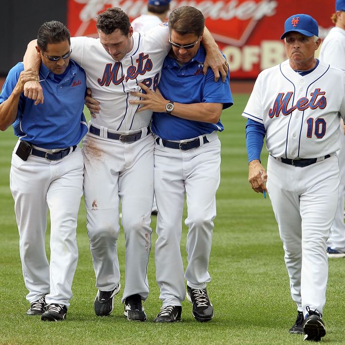 NEW YORK, NY - AUGUST 07: Daniel Murphy #28 of the New York Mets is helped off the field by head trainer Ray Ramirez (L), trainer Mike Herbst and manager Terry Collins #10 after a seventh inning injury trying to prevent a stolen base against the Atlanta Braves at Citi Field on August 7, 2011 in the Flushing neighborhood of the Queens borough of New York City. (Photo by Jim McIsaac/Getty Images)