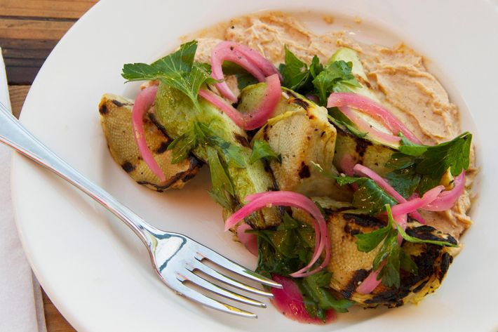 Artichoke-and-chayote salad with spiced yogurt and pickled onion.