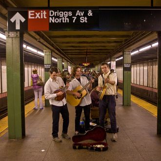 A group of musicians play their instruments in a Williamsburg subway station on May 5, 2012 in New York City. Over the past five years, Williamsburg has become a magnet for youthful artists, musicians, chefs, mixologists and fashion designers. 