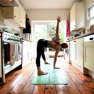Beautiful woman practicing yoga at home. Stylish cozy home
