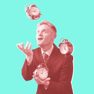 Businessman juggling with alarm clocks.