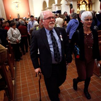 TUCSON, AZ- JANUARY 8: Ron Barber (center), who was wounded in last years deadly shooting, exits after attending an interfaith memorial service held at St. Augustine Cathedral January 8, 2012 in Tucson, Arizona. Memorial services will be held throughout the day in Tucson to commemorate the one year anniversary of a shooting rampage that killed six people and wounded more than a dozen more including U.S. Rep. Gabrielle Giffords (D-AZ). (Photo by Jonathan Gibby/Getty Images)