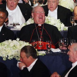 NEW YORK, NY - OCTOBER 18: (L - R) U.S. President Barack Obama, Roman Catholic Cardinal and Archbishop of New York Timothy Dolan, and Republican presidential candidate Mitt Romney share a laugh at the 67th Annual Alfred E. Smith Memorial Foundation Dinner at the Waldorf-Astoria Hotel on October 18, 2012 in New York City. The lighthearted white-tie charity gala has long been a tradition of the presidential race. (Photo by Mario Tama/Getty Images)