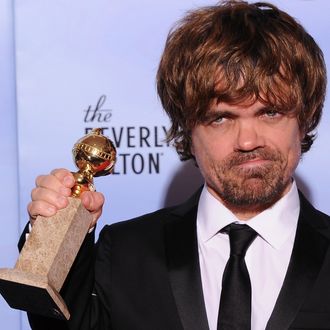 The winner for Best Performance by an Actor in a Supporting Role in a Series, Mini-Series or Motion Picture Made for Television Peter Dinklage poses with the trophy at the 69th annual Golden Globe Awards at the Beverly Hilton Hotel in Beverly Hills, California, January 15, 2012. AFP PHOTO / Robyn BECK (Photo credit should read ROBYN BECK/AFP/Getty Images)