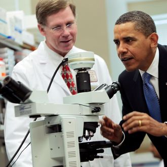 BETHESDA, MD - SEPTEMBER 30: (AFP OUT) U.S. President Barack Obama looks at brain cells in a microscope during a tour of a laboratory with Health & Human Services Secretary Kathleen Sebelius (not seen) at the National Institutes of Health September 30, 2009 in Bethesda, Maryland. After the visit, Obama announced five billion USD in grant awards under the American Recovery and Reinvestment Act of 2009 to fund cutting-edge medical research in every state across America. (Photo by Aude Guerrucci-Pool/Getty Images) *** Local Caption *** Barack Obama