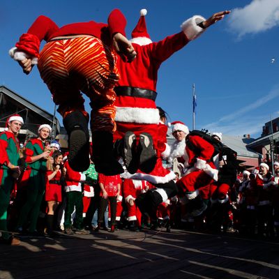 NEW YORK, NY - DECEMBER 10: Revelers dressed as Santa Claus play jump rope during the annual SantaCon event December 10, 2011 in New York City. SantaCon is a mass gathering of revelers dressed as Santa Claus who take to the streets in cities across the country before Christmas. (Photo by Allison Joyce/Getty Images)