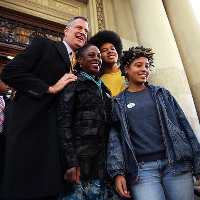 New York Democratic mayoral candidate Bill de Blasio poses with his family, wife Chirlane McCray, son Dante de Blasio and daughter Chiara de Blasio after voting at a public library branch on Election Day on November 5, 2013 in the Brooklyn borough of New York City. De Blasio leads in the polls over his challenger Republican mayoral candidate Joe Lhota by double digit points. 