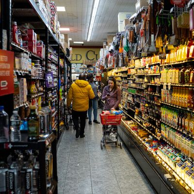 A woman shopping at a New York City Key Food, standing in the juice aisle
