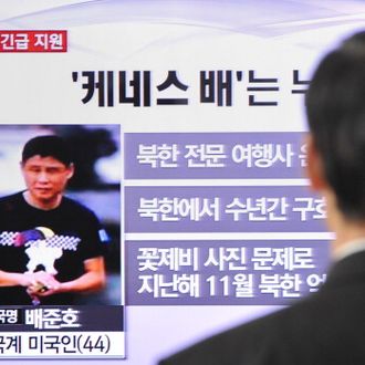 A passerby watches a local television broadcast in Seoul on May 2, 2013 showing a report and picture of Kenneth Bae (L), a Korean-American tour operator detained in North Korea. North Korea said on May 2 it had sentenced a Korean-American tour operator to 15 years' hard labour for 'hostile acts', stoking tensions with the United States, which had pleaded for his release.
