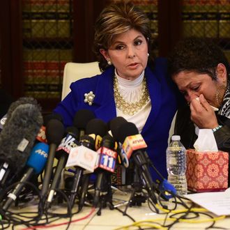 Women's rights attorney Gloria Allred (C) comforts a grieving Chelan (one name) and Helen Hayes (L) during a press conference in Los Angeles on December 3, 2014. Three women who alleged they were victims of the actor spoke to the media.