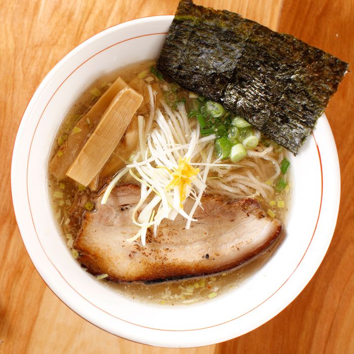 The signature yuzu shoyu ramen with seaweed, bamboo shoots, sliced pork belly (or chicken), and scallion.