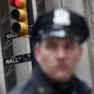 Police stand by as protesters march to Wall Street during an ACT-UP and Occupy Wall Street demonstration on April 25, 2012 in New York City. ACT-UP (AIDS Coalition to Unleash Power), was marking their 25-year anniversary in supporting services for people with AIDS worldwide. They were joined by Occupy Wall Street protesters in a march from New York's city hall to Wall Street. The groups called for a tax on Wall Street transactions and speculative trades to raise money for to end the global AIDS epidemic and provide universal healthcare in the U.S. 