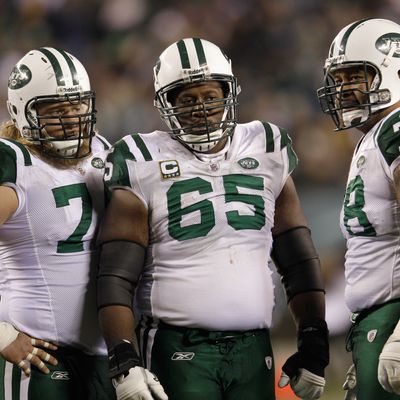 Nick Mangold #74, Brandon Moore #65, and Wayne Hunter #78 of the New York Jets gather in the huddle during the second half of the Jets 45-19 loss to the Philadelphia Eagles at Lincoln Financial Field on December 18, 2011 in Philadelphia, Pennsylvania.