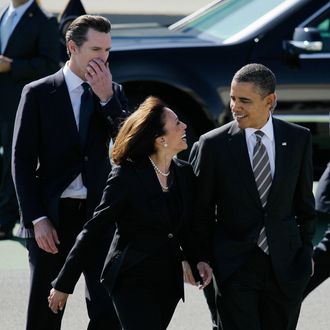 In this Feb. 16, 2012 file photo President Barack Obama walks with California Attorney General Kamala Harris, center, and California Lt. Gov. Gavin Newsom, after arriving at San Francisco International Airport in San Francisco. Obama praised California's attorney general for more than her smarts and toughness at a Democratic Party event Thursday, April 4, 2013. The president also commended Harris for being 