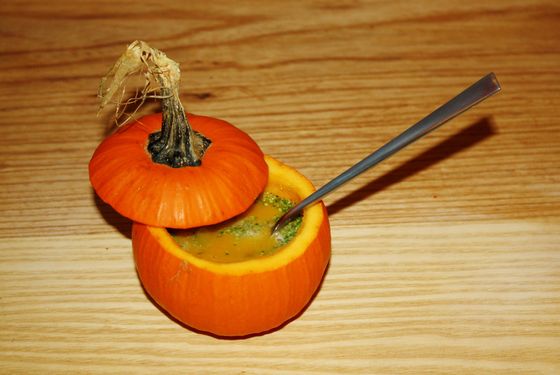 Pumpkin soup with broccoli, Parmesan, green tomatoes, and pepitas.