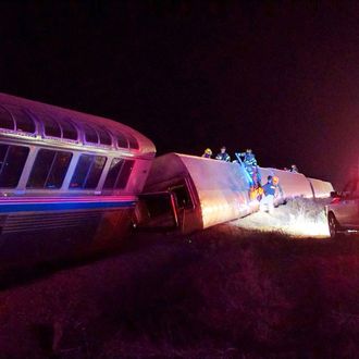 Emergency personnel work on a train that derailed near Dodge City, Kan., Monday, March 14, 2016. An Amtrak statement says the train was traveling from Los Angeles to Chicago early Monday when it derailed just after midnight. (Daniel Szczerba via AP) MANDATORY CREDIT