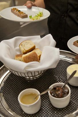 A foie gras and turkey-liver mousse, with Parker House rolls and garnishes: turkey schmaltz, pecan-pie filling, and salted butter.