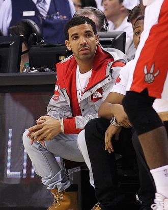 TORONTO, ON - APRIL 19: Rap star Drake takes in the action between the Brooklyn Nets and the Toronto Raptors in Game One of the NBA Eastern Conference play-off at the Air Canada Centre on April 19, 2014 in Toronto, Ontario, Canada. The Nets defeated the Raptors 94-87 to take a 1-0 series lead. NOTE TO USER: user expressly acknowledges and agrees that, by downloading and/or using this Photograph, user is consenting to the terms and conditions of the Getty Images License Agreement. (Photo by Claus Andersen/Getty Images) *** Local Caption *** Drake