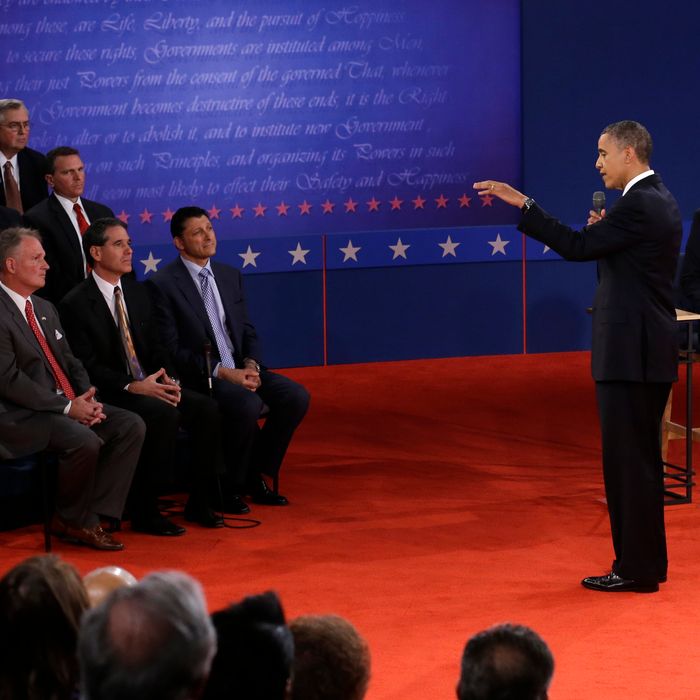 President Barack Obama answers a question as Republican presidential nominee Mitt Romney listens during the second presidential debate at Hofstra University, Tuesday, Oct. 16, 2012, in Hempstead, N.Y. (AP Photo/Charlie Neibergall)