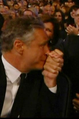 Jon Stewart demonstrates his new and unexpected arm-wrestling maneuver: the knuckle nuzzle.