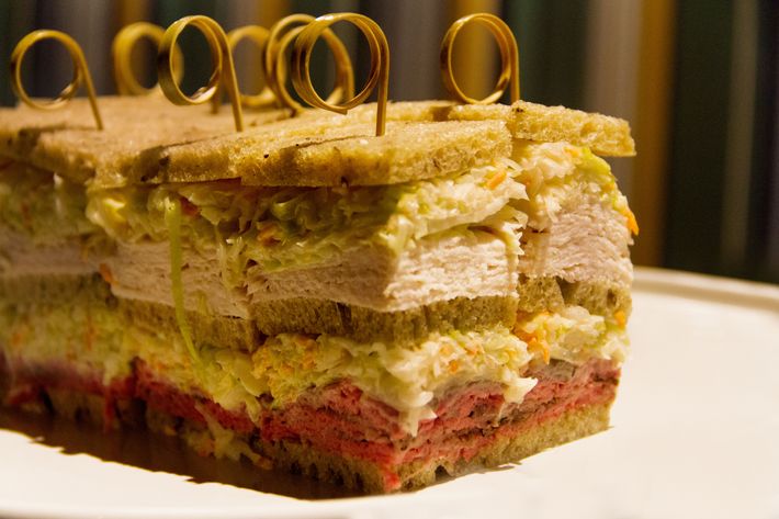 Triple-decker sandwich with turkey and roast beef.