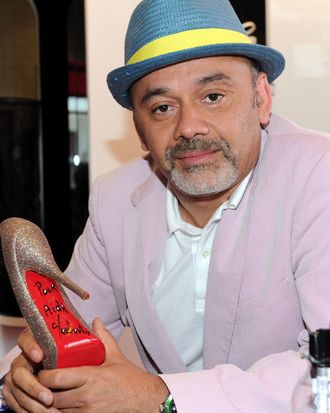 WEST HOLLYWOOD, CA - APRIL 28: Designer Christian Louboutin poses for a photo at the grand opening of the new Christian Louboutin boutique on April 28, 2010 in West Hollywood, California. (Photo by Alberto E. Rodriguez/Getty Images)