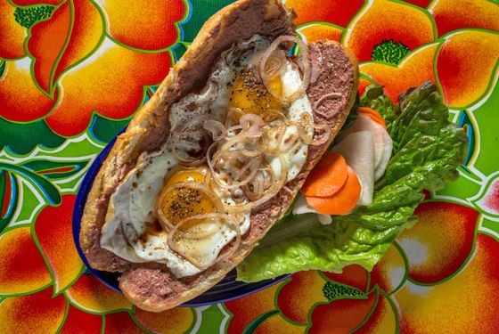 Two Fried Eggs on a Baguette with duck liver and maggi sauce.