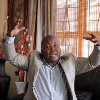Thamsanqa Jantjie gesticulates at his home during an interview with the Associated Press in Johannesburg, South Africa,Thursday, Dec. 12, 2013. Jantjie, the man accused of faking sign interpretation next to world leaders at Nelson Mandela's memorial, told a local newspaper that he was hallucinating and hearing voices.