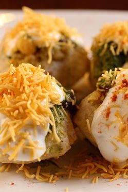 Small hollow puri with potatoes, chutney, tamarind water, and spices
