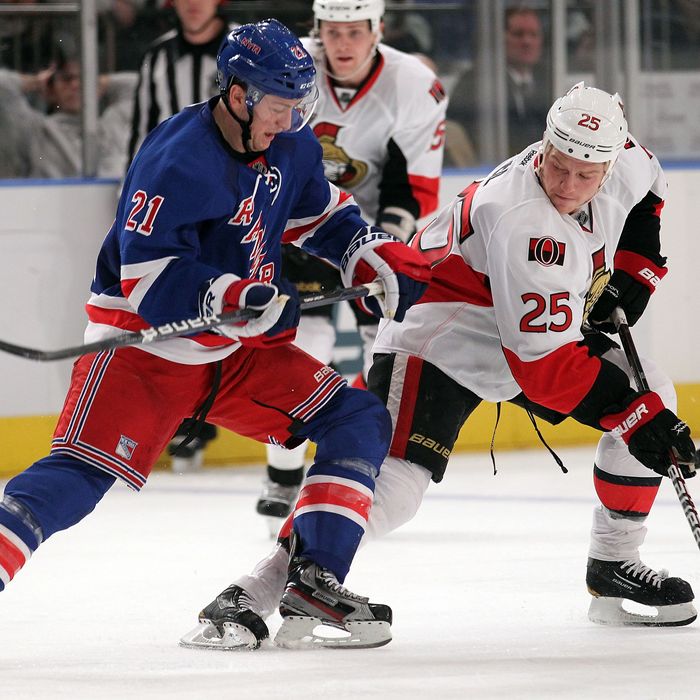 NEW YORK, NY - JANUARY 12: Derek Stepan #21 of the New York Rangers skates alongside Chris Neil #25 of the Ottawa Senators at Madison Square Garden on January 12, 2012 in New York City. (Photo by Nick Laham/Getty Images)