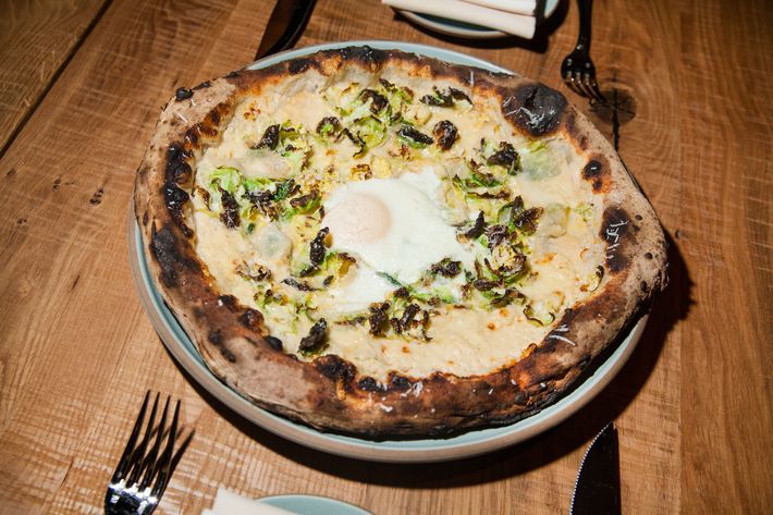 The fontina-and-Brussels-sprout pizza with optional egg is cooked in a wood-burning Stefano Ferrara oven.