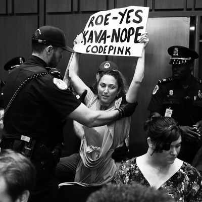 Protester escorted out during the Kavanaugh hearing.