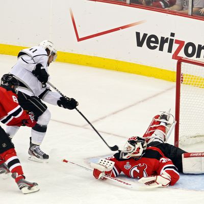 Anze Kopitar #11 of the Los Angeles Kings shoots the game winning goal in overtime against Dainius Zubrus #8 and Martin Brodeur #30 of the New Jersey Devils during Game One of the 2012 NHL Stanley Cup Final at the Prudential Center on May 30, 2012 in Newark, New Jersey. 