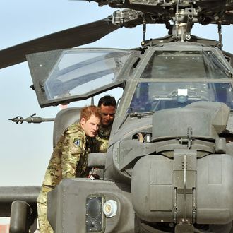 CAMP BASTION, AFGHANISTAN - SEPTEMBER 07: Prince Harry examines the 30mm cannon of an Apache helicopter with a member of his squadron (name not provided) on September 7, 2012 at Camp Bastion, Afghanistan. Prince Harry has been redeployed to the region to pilot attack helicopters. (Photo by John Stillwell - Pool/Getty Images)