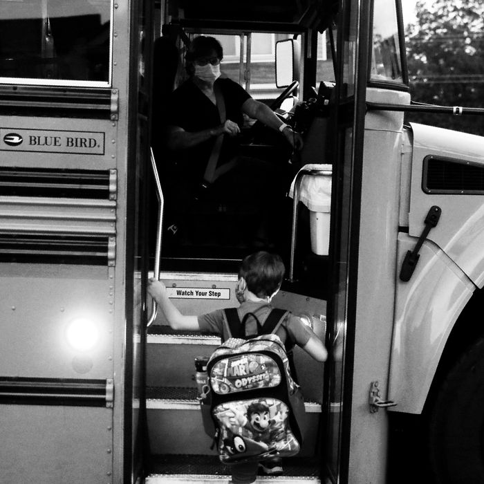 A student boards a school bus.