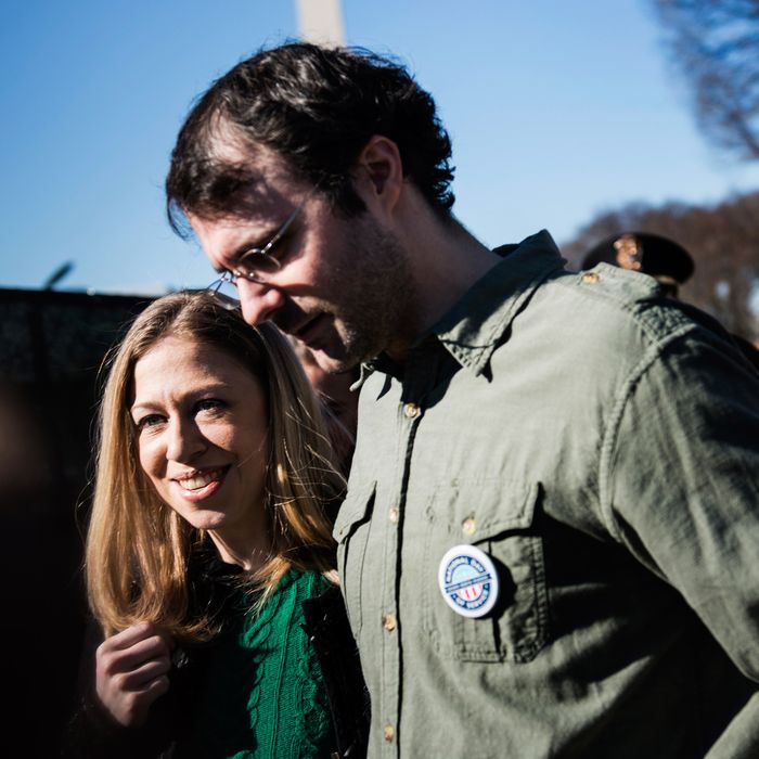 Chelsea Clinton and her husband Marc Mezvinsky walk on the National Mall January 19, 2013 in Washington, DC.