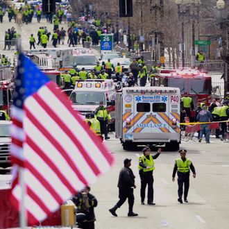 Emergency workers aid injured people at the finish line of the 2013 Boston Marathon following an explosion in Boston, Monday, April 15, 2013.