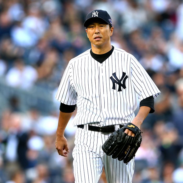 Hiroki Kuroda #18 of the New York Yankees walks back to the dugout at the end of the top of the first inning against the Detroit Tigers during Game Two of the American League Championship Series at Yankee Stadium on October 14, 2012 in the Bronx borough of New York City.