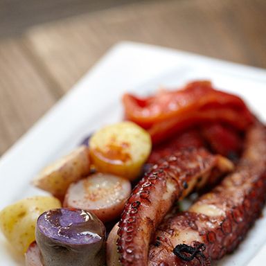 Grilled octopus and baby potatoes, roasted peppers, and pimenton de la vera