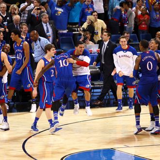 Tyshawn Taylor #10 of the Kansas Jayhawks celebrates with his teammates after they won 80-67 against the North Carolina Tar Heels during the 2012 NCAA Men's Basketball Midwest Regional Final 