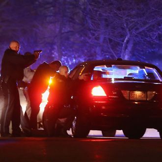 WATERTOWN, MA - APRIL 19: (ALTERNATE CROP) Police with guns drawn search for a suspect on April 19, 2013 in Watertown, Massachusetts. Earlier, a Massachusetts Institute of Technology campus police officer was shot and killed late Thursday night at the school's campus in Cambridge. A short time later, police reported exchanging gunfire with alleged carjackers in Watertown, a city near Cambridge. It's not clear whether the shootings are related or whether either are related to the Boston Marathon bombing. (Photo by Mario Tama/Getty Images)