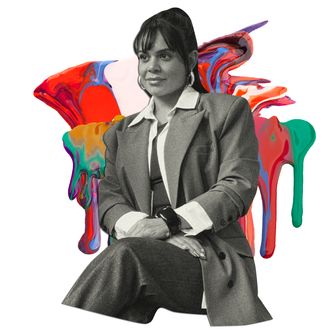 A woman wearing a suit sits for a portrait. Her dark hair is pulled back and she&rsquo;s looking off to her right.